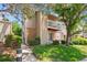 Two-story exterior showcasing a well-maintained lawn, mature trees, and a charming balcony at 4656 S Dillon Ct # D, Aurora, CO 80015