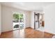 Open-concept living area with hardwood floors, a kitchen view, and natural light from sliding doors at 4656 S Dillon Ct # D, Aurora, CO 80015