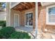Outdoor patio area with brick facade, sliding glass door, and manicured landscape at 4656 S Dillon Ct # D, Aurora, CO 80015