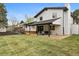 Spacious backyard featuring a covered patio, lush lawn, and well-maintained landscaping at 7114 S Costilla St, Littleton, CO 80120