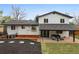 Aerial view of backyard with covered patio, dining set, lush lawn, and garden beds at 7114 S Costilla St, Littleton, CO 80120