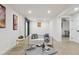 Basement living area with white couch, decor, and light wood-look flooring at 7114 S Costilla St, Littleton, CO 80120