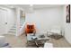 Basement living area offering a cozy space with modern furnishings and easy access to stairs at 7114 S Costilla St, Littleton, CO 80120
