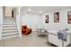 Spacious finished basement featuring stairs, unique furniture, and stylish decor at 7114 S Costilla St, Littleton, CO 80120