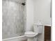 Modern bathroom featuring a tiled walk-in shower, toilet, and floating vanity at 7114 S Costilla St, Littleton, CO 80120