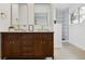 Bathroom with double vanity featuring sleek mirrors, elegant fixtures, and ample storage at 7114 S Costilla St, Littleton, CO 80120
