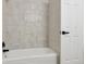 Bright bathroom featuring a new tub with white tiling at 7114 S Costilla St, Littleton, CO 80120