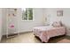 Charming bedroom with light-colored wooden floors, and a pink bed and decor at 7114 S Costilla St, Littleton, CO 80120