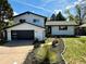 Charming two-story home boasting black trim, modern garage door and meticulous landscaping in a beautiful suburban neighborhood at 7114 S Costilla St, Littleton, CO 80120