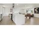 Bright kitchen featuring a large island, stainless steel appliances, and open layout to the living space at 7114 S Costilla St, Littleton, CO 80120