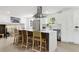 Kitchen boasts a large island with seating, stainless steel appliances, and bright, open layout at 7114 S Costilla St, Littleton, CO 80120