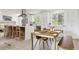 Modern kitchen features white cabinets, breakfast bar, stainless steel appliances and a seamless connection to the dining area at 7114 S Costilla St, Littleton, CO 80120