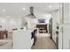 Open concept kitchen featuring a kitchen island with breakfast bar and stainless steel appliances at 7114 S Costilla St, Littleton, CO 80120