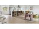 Open concept living space with breakfast bar, sleek appliances, and dining area; perfect for modern living at 7114 S Costilla St, Littleton, CO 80120