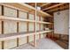 Unfinished storage area with built-in shelving and ample room for organization and safekeeping at 7114 S Costilla St, Littleton, CO 80120