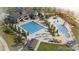 Scenic aerial of a clubhouse featuring two pools, umbrellas, and lounge chairs at 7202 S Valleyhead Ct, Aurora, CO 80016