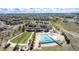 Stunning aerial view of the community clubhouse featuring a pool, fire pit, and green space at 7202 S Valleyhead Ct, Aurora, CO 80016