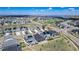 Wide aerial shot of a suburban neighborhood featuring similar-style homes with solar panels, green spaces, and well-maintained roads at 7202 S Valleyhead Ct, Aurora, CO 80016