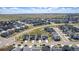 Wide aerial shot of a suburban neighborhood featuring similar-style homes, green spaces, and well-maintained roads at 7202 S Valleyhead Ct, Aurora, CO 80016