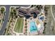 Aerial view of a community clubhouse and pool area, showcasing a large pool, green lawn, and outdoor seating at 7202 S Valleyhead Ct, Aurora, CO 80016