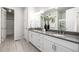 Modern bathroom with double sink vanity, quartz countertops, and tile flooring at 7202 S Valleyhead Ct, Aurora, CO 80016