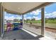 Charming covered patio with picturesque views, colorful chairs and a serene outdoor setting at 7202 S Valleyhead Ct, Aurora, CO 80016