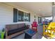 Relaxing covered patio featuring comfortable seating, ambient lighting, and a cozy fire pit at 7202 S Valleyhead Ct, Aurora, CO 80016