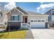 Charming single-Gathering home featuring a well-manicured lawn, two-car garage, and inviting front entrance at 7202 S Valleyhead Ct, Aurora, CO 80016