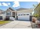 A well-maintained house showcasing a two-car garage, well-kept landscaping, and inviting curb appeal at 7202 S Valleyhead Ct, Aurora, CO 80016