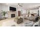 Comfortable living space with a stone fireplace, open floor plan, and modern decor at 7202 S Valleyhead Ct, Aurora, CO 80016