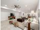 Bright living room featuring modern decor and an open concept design leading to the kitchen at 7202 S Valleyhead Ct, Aurora, CO 80016