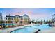Resort-style pool area with lounge chairs, splash pad, and modern clubhouse at 7202 S Valleyhead Ct, Aurora, CO 80016