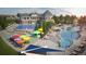 Community center with swimming pool, splash pad, sun umbrellas, and lounge chairs at 7202 S Valleyhead Ct, Aurora, CO 80016