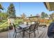 Landscaped backyard featuring a patio with outdoor seating, a playhouse, and lush greenery at 1465 S Urban Way, Lakewood, CO 80228