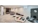 Basement area with gray furnishings, a fireplace and rec equipment; great for relaxing or exercising at 1465 S Urban Way, Lakewood, CO 80228