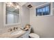 Updated bathroom features granite countertops, a tiled shower, and a basket for storing necessities at 1465 S Urban Way, Lakewood, CO 80228