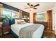 Cozy bedroom featuring a ceiling fan, hardwood floors, and abundant natural light at 1465 S Urban Way, Lakewood, CO 80228
