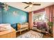 Bedroom with hardwood floors, accent wall, mobile and wooden crib at 1465 S Urban Way, Lakewood, CO 80228