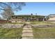 Charming single-story home with a well-manicured lawn and inviting front entrance with beautiful steps at 1465 S Urban Way, Lakewood, CO 80228