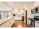 Bright kitchen with white cabinets, stainless steel appliances, sleek countertops, and views of the outdoor patio at 1465 S Urban Way, Lakewood, CO 80228