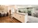 Kitchen area featuring an island with grey countertops, dining area, and plenty of natural light at 1465 S Urban Way, Lakewood, CO 80228