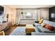 Bright living room featuring large window, contemporary decor, hardwood floors, and a cozy seating area at 1465 S Urban Way, Lakewood, CO 80228