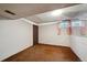 Finished basement area with carpet, drywall, and a window, with a brown wooden door at 8731 W 89Th Pl, Broomfield, CO 80021