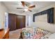 View of bedroom with a ceiling fan, window with blinds, wooden dresser and a colorful quilt on the bed at 8731 W 89Th Pl, Broomfield, CO 80021