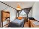 Bedroom featuring a single bed, window with floral drapes, wooden built in hutch and dresser at 8731 W 89Th Pl, Broomfield, CO 80021