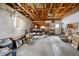 Spacious garage with exposed wood beams, tools and open workbench at 8731 W 89Th Pl, Broomfield, CO 80021