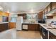 Functional kitchen with classic cabinets and appliances, including a white refrigerator at 8731 W 89Th Pl, Broomfield, CO 80021