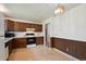 Well-lit kitchen featuring dark cabinets, linoleum flooring, and modern appliances at 8731 W 89Th Pl, Broomfield, CO 80021