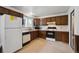 Efficient kitchen with dark cabinets, offering essential appliances and counter space at 8731 W 89Th Pl, Broomfield, CO 80021