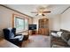 Inviting living room with large window for natural light, ceiling fan and plush sofa at 8731 W 89Th Pl, Broomfield, CO 80021